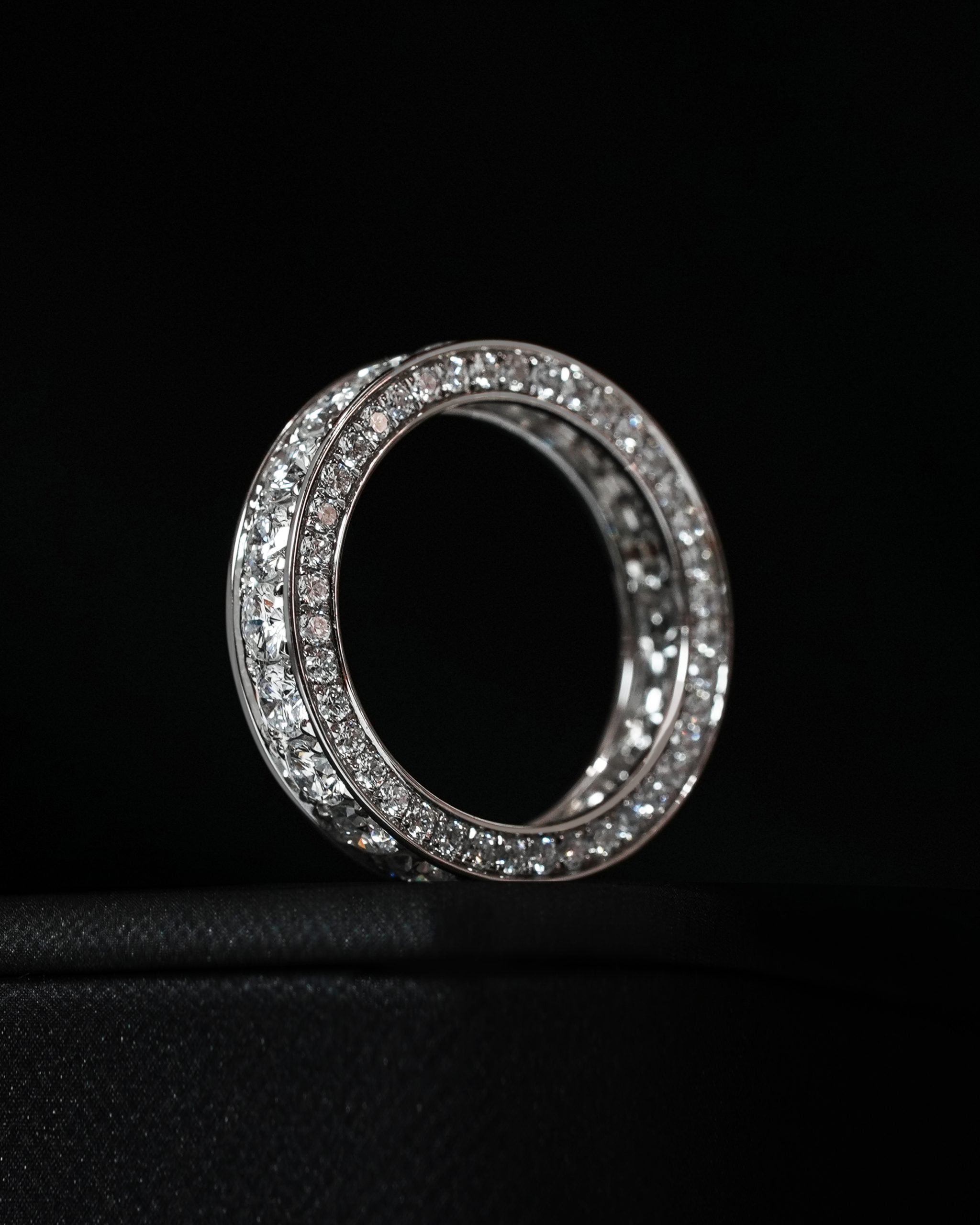 celina-half-eternity-ring-black-bg. Celina Half Eternity Ring – round cut diamonds on black background