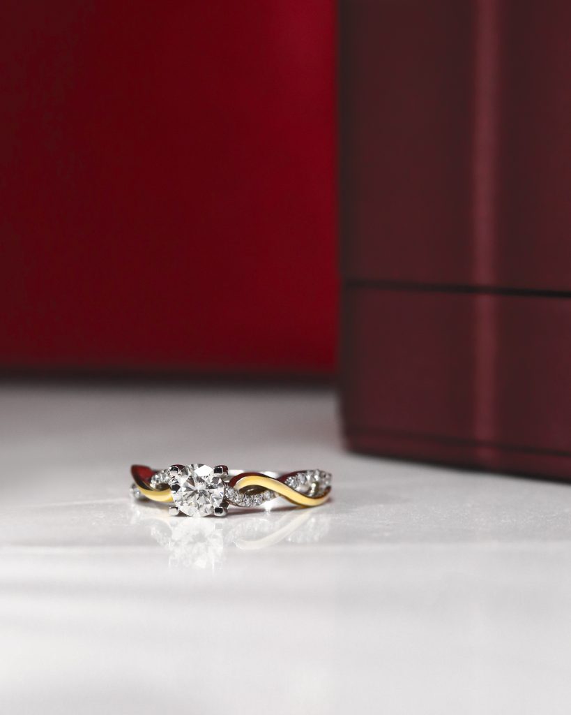 Product display of rings and stones on minimalist white background