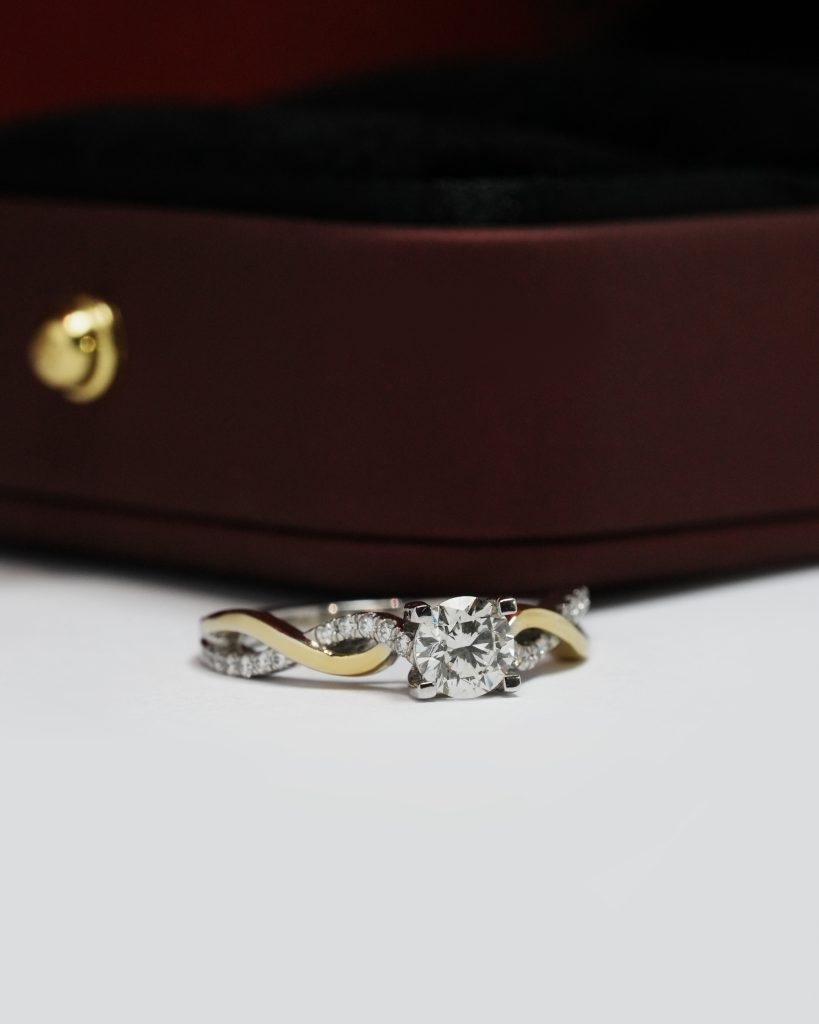 Diamond ring displayed on dark jewelry box